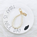 Estuche rígido para AirPods 1/2 con correa de mano de perla color rosa en Guatemala.